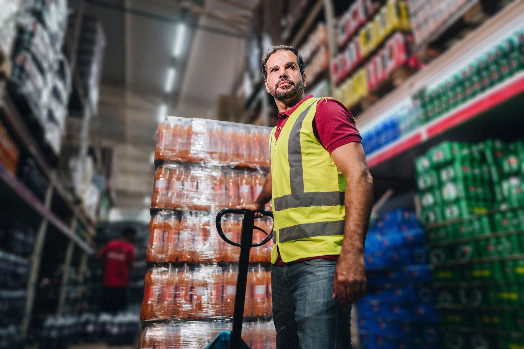 Worker moving materials with a hand truck